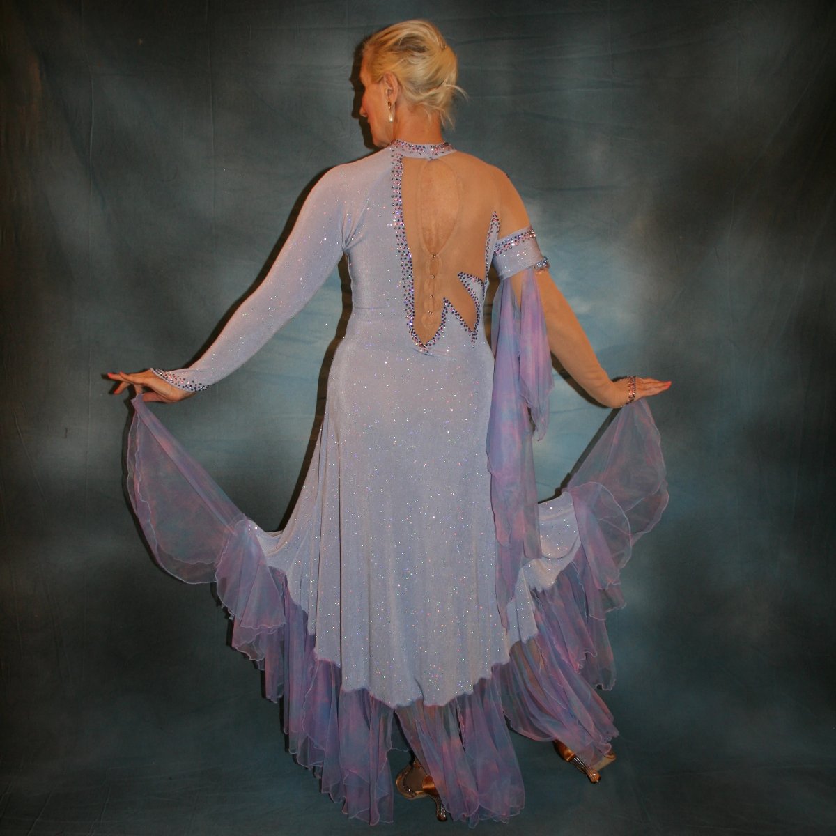 Crystal's Creations back view of Blue ballroom dress created in periwinkle blue luxurious glitter slinky on nude illusion base with tricot chiffon flounces in shades of perwinkle & soft pink