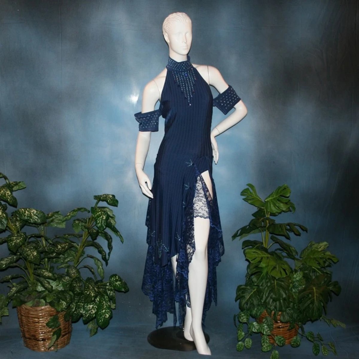 Navy blue tango dress or Latin/rhythm dress created in rib textured lycra, with flounces of barcelona lace, adorned with light sapphire Swarovski rhinestones & larger navy lucite gems.