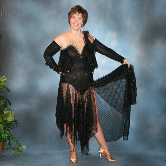 Black tango dress created in slinky glitterknit with glitter lace flounces & skirting. Jet Ab Swarovski rhinestones embellish the nude illusion chest as well as peak of sleeves…with a finishing touch of silk black iridescent roses & orchids that have a hint of green.