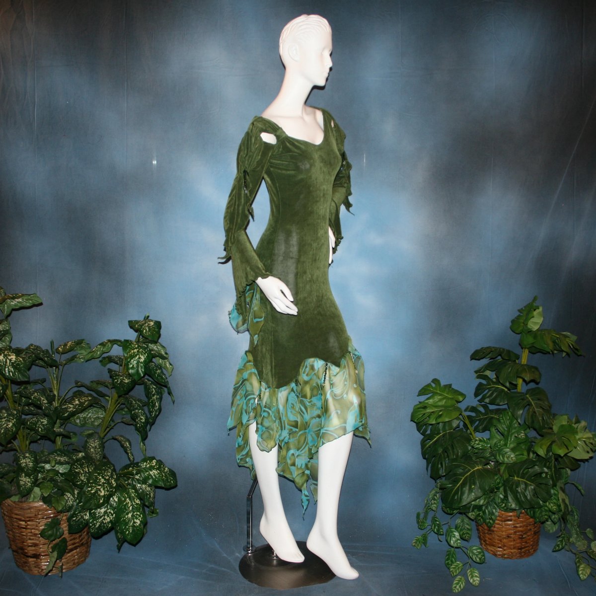 Side view of Green ballroom social/Latin/rhythm dress created in luxurious olive green solid slinky fabric with chiffon flounces of an olive green & teal print, is embellished with Swarovski hand beading. The arms have a beautiful, romantic & unique detailing! A great social dress for any ballroom dance or special occasion, as well as a great beginner ballroom dance show dress!