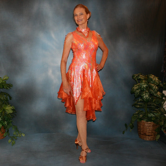 Crystal's Creations Orange Latin/rhythm dress was created in orange & silver metallic print lycra with oodles of glitter organza flounces & accents, has back strap detailing, embellished with extensive Swarovski hand beading & has matching Swarovski hand beaded neckpiece.