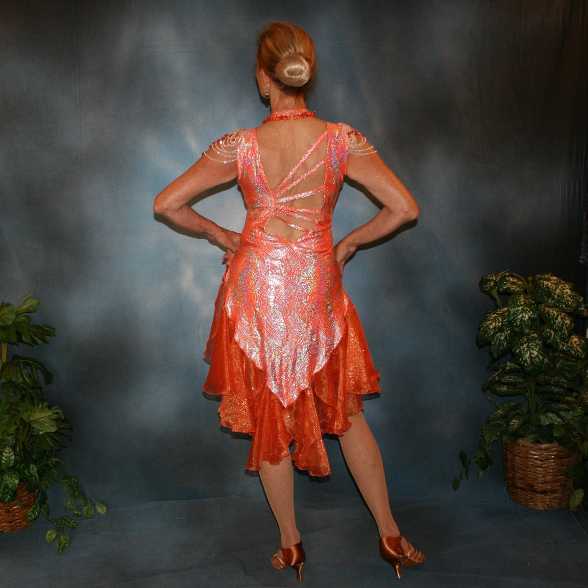Crystal's Creations back view of Orange Latin/rhythm dress was created in orange & silver metallic print lycra with oodles of glitter organza flounces & accents, has back strap detailing, embellished with extensive Swarovski hand beading & has matching Swarovski hand beaded neckpiece.