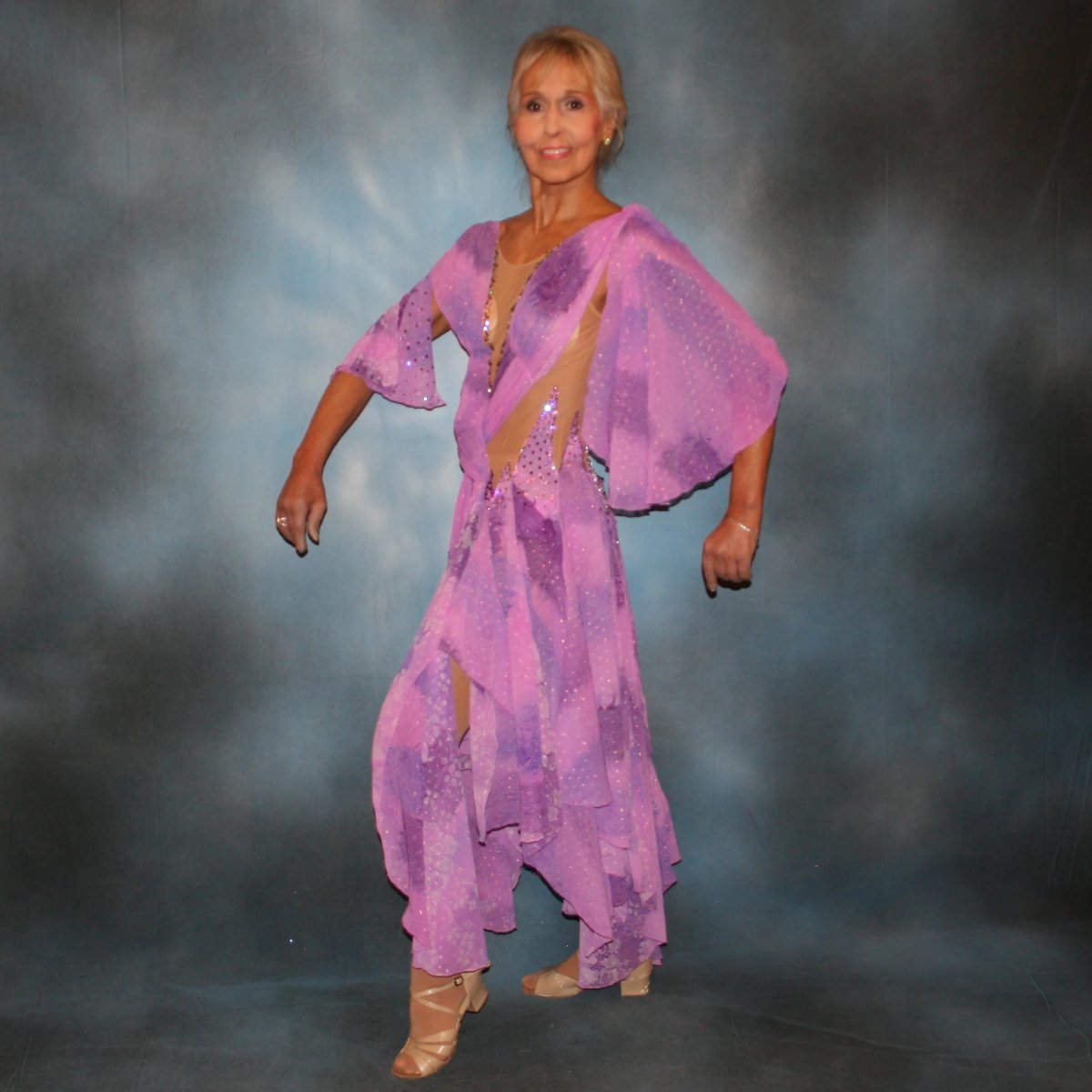 Crystal's Creations side view of Orchid ballroom dress created in yards of a textured chiffon in shades of orchids & purples on a nude illusion base with floats & Swarovski stonework in gorgeous shades of orchids & purples.