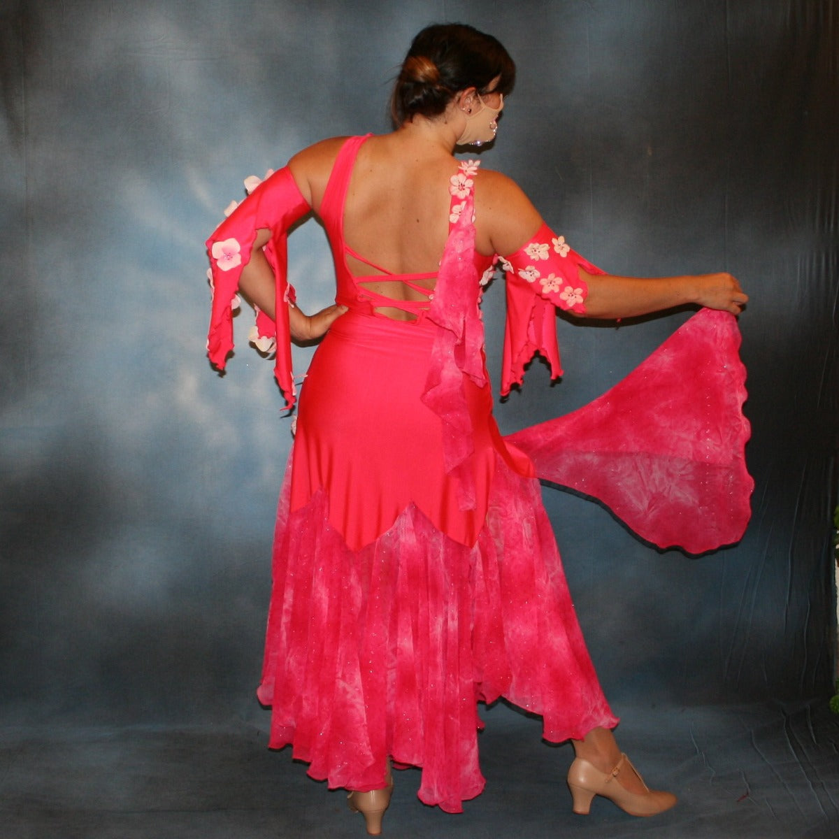Crystal's Creations back view of  deep pink ballroom dress created of Indian pink lycra base with yards & yards of Indian pink print chiffon large & flowing flounces, embellishing done with silk flowers, accented with Swarovski stonework in Indian pink 