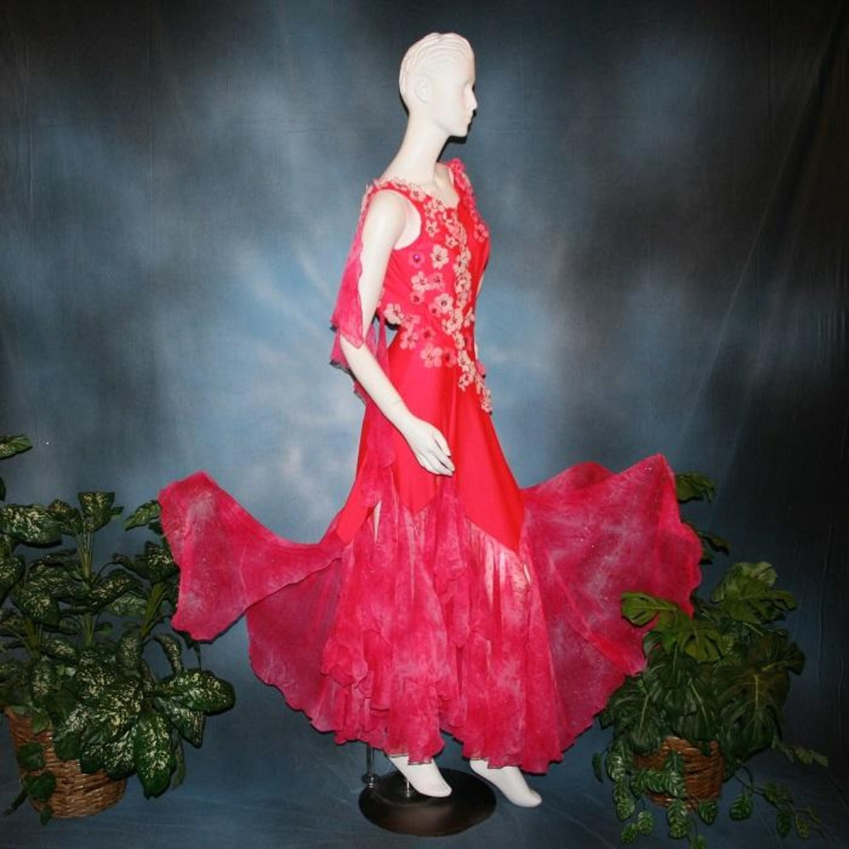Crystal's Creations side view of Deep pink ballroom dress created of Indian pink lycra base with yards & yards of Indian pink print chiffon large & flowing flounces, embellishing done with silk flowers, accented with Swarovski stonework in Indian pink .