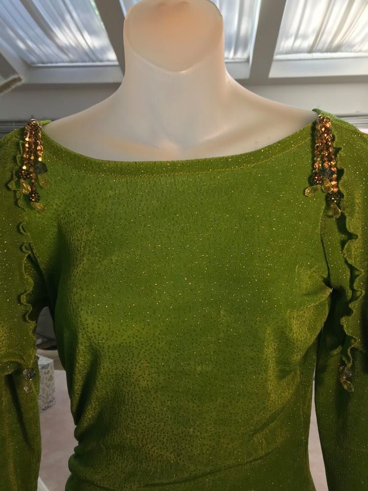 shoulder detail of Apple green social Latin/rhythm dress was created of apple green glitter slinky, features ruching on the right side, long sleeves, scoop back, & full skirting with open side that has Swarovski hand beaded detail