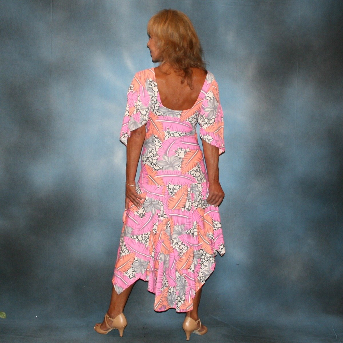 back view of Pink tropical print lycra dress created of pink, orange, white & black tropical print lycra with full flare sleeves & full circle skirt, with a bodysuit base, so a great dress for Latin/rhythm dance practice ballroom teacher dress, especially if you work on drops & lifts! 