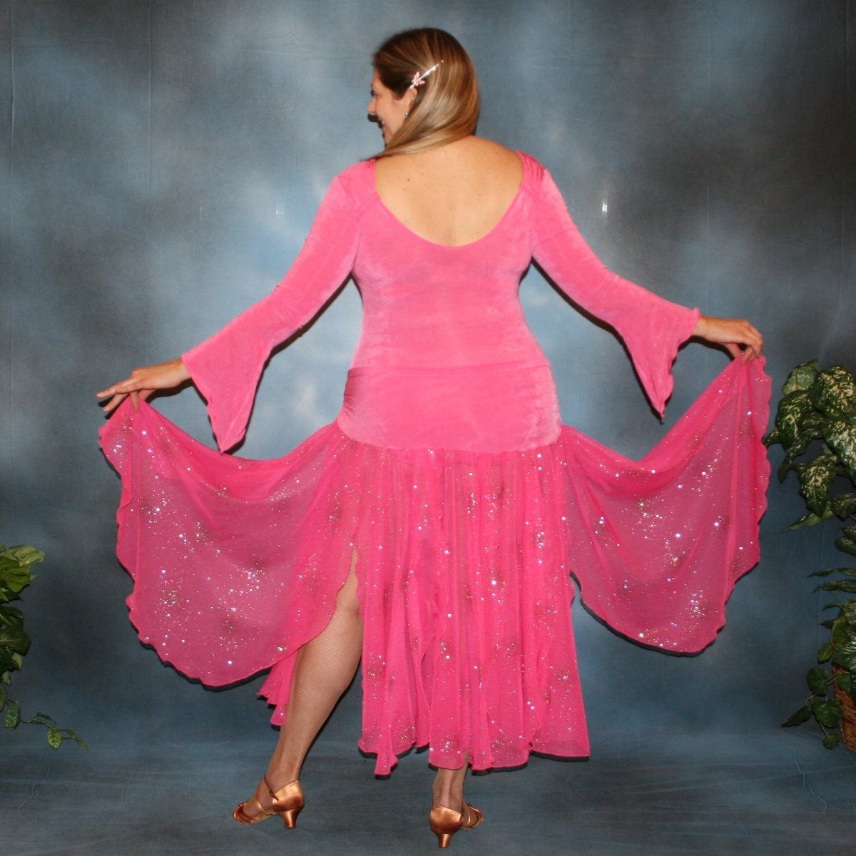 Crystal's Creations back view of Bubble gum pink solid slinky body suit with long flaired sleeves includes 3 ballroom skirts, one for smooth with yards of glitter chiffon, a 2nd, with oodles of print chiffon flounces, which is great for rumba, bolero or tango & a 3rd of solid slinky to wear for Latin/rhythm dancing