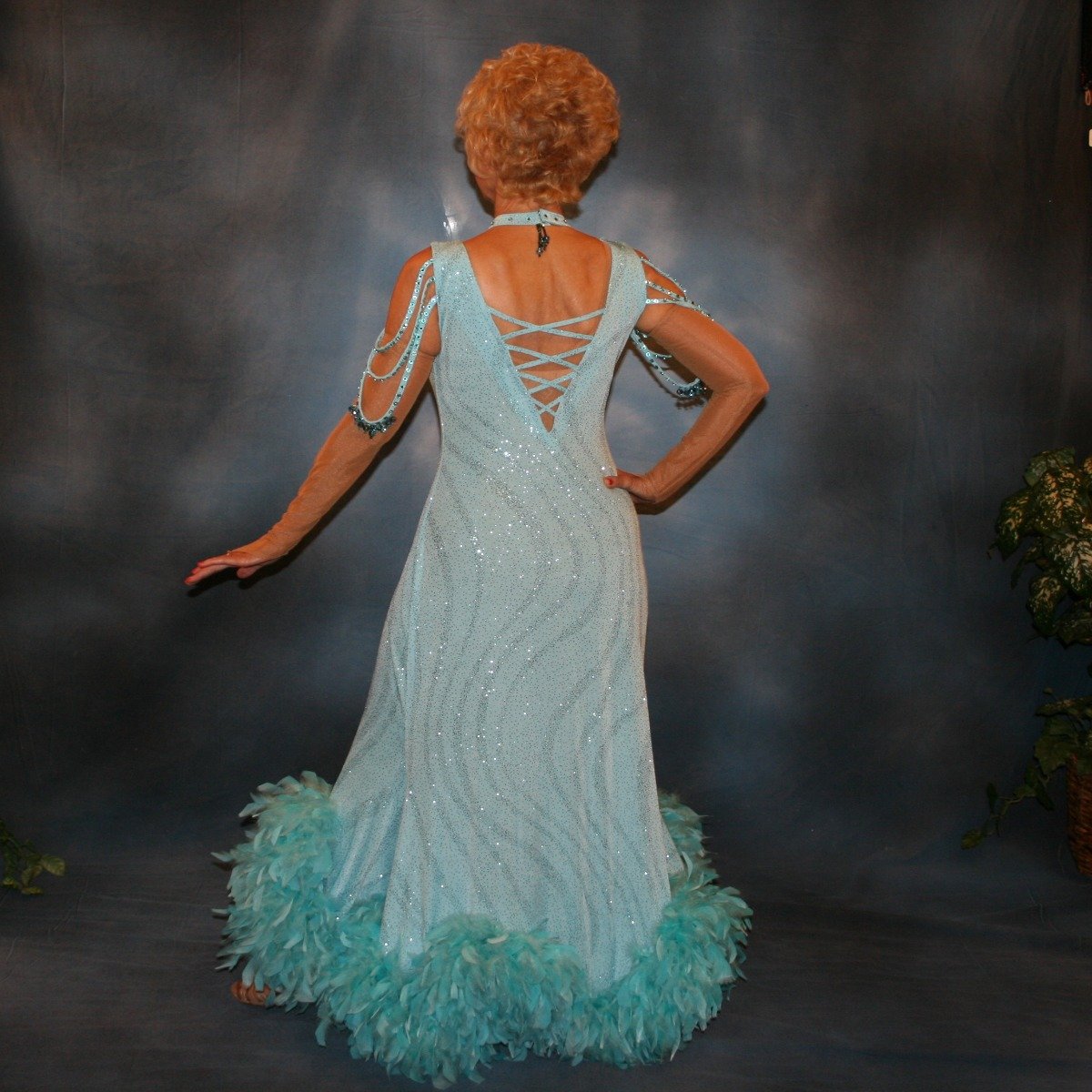 Crystal's Creations back view of Soft blue ballroom dress with chandelle feathers was created of a gorgeous glitter slinky with a wave pattern, has strap detailing on the low back, embellished with Swarovski rhinestones & hand beading on the arm draping straps & matching neck piece.