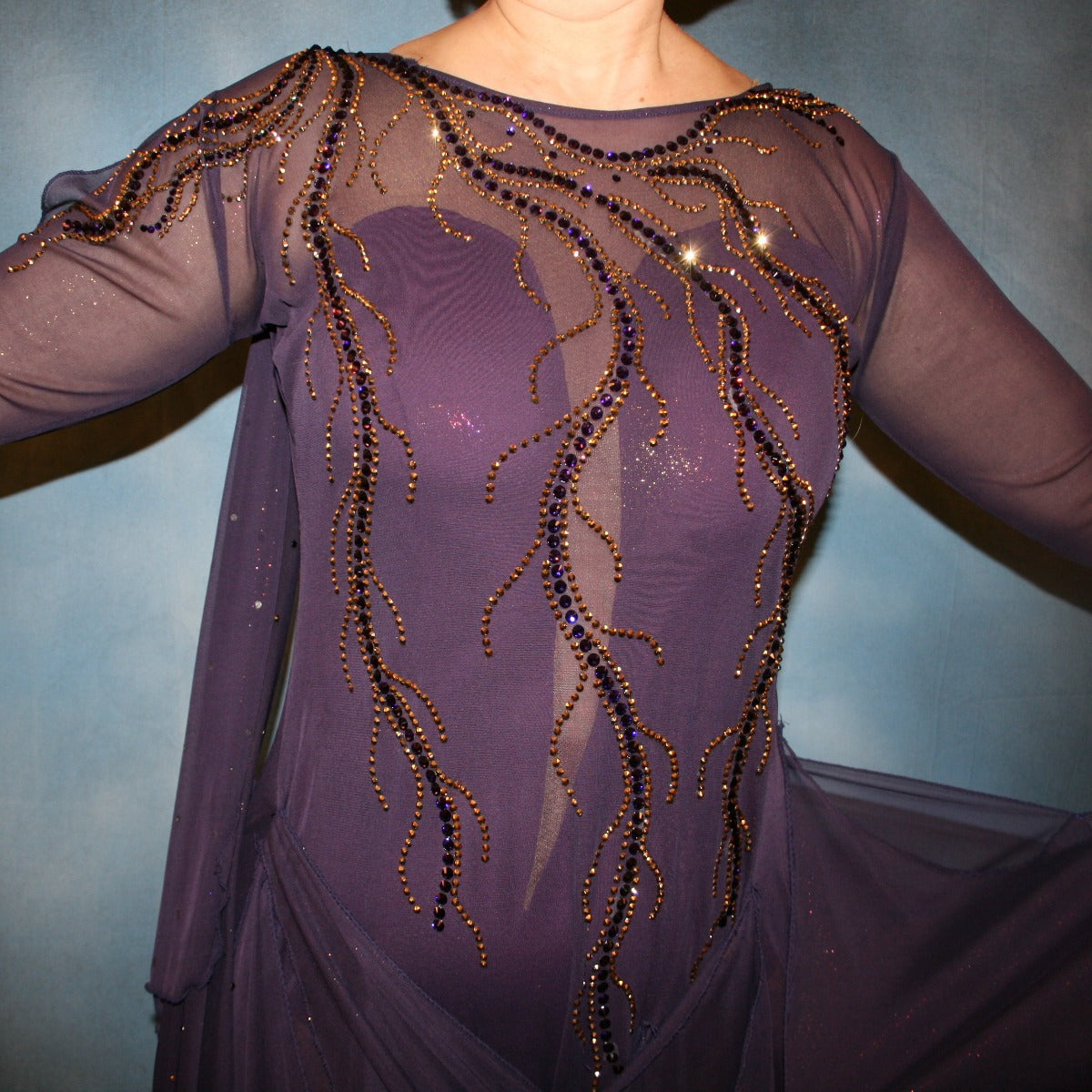 Crystal's Creations close up of Purple ballroom dress created in gorgeous deep plum iridescent sheer mesh with draping floats, embellished with gold aurum & purple velvet Swarovski rhinestone work