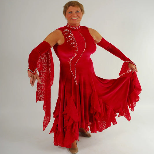 Red ballroom dress was created in luxurious red stretch velvet with clip-n-cut chiffon insets & flounces & inset down bodice with matching gauntlets...embellished with CAB Swarovski rhinestones & has keyhole back.