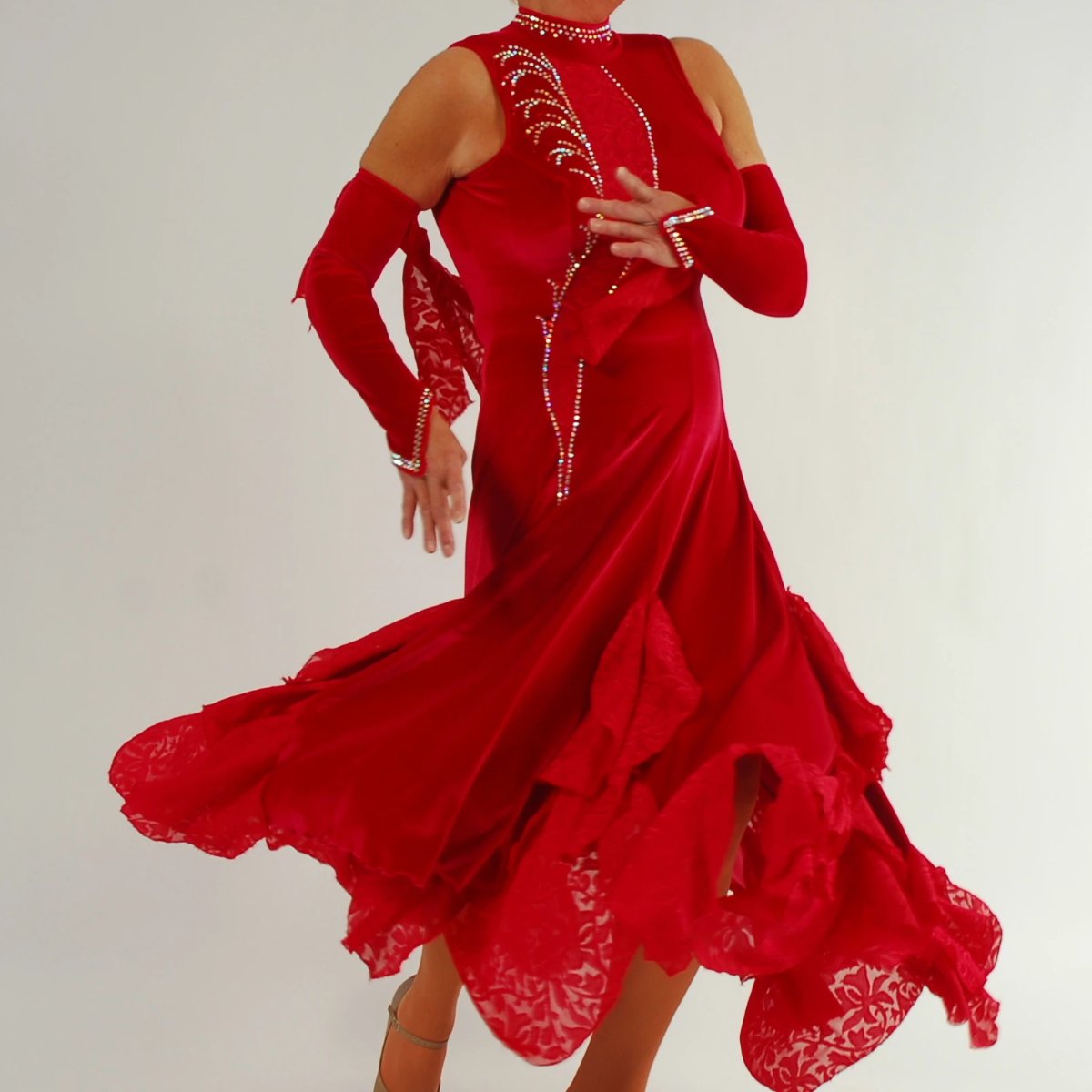 swirling view of Red ballroom dress was created in luxurious red stretch velvet with clip-n-cut chiffon insets & flounces & inset down bodice with matching gauntlets...embellished with CAB Swarovski rhinestones & has keyhole back. 