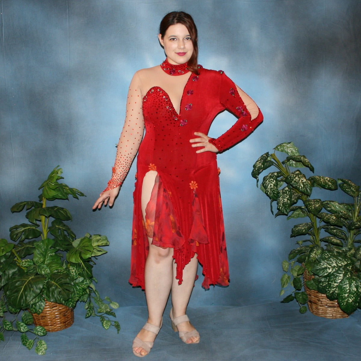 Red Latin/rhythm dance dress created in luxurious red solid slinky over nude illusion base with printed chiffon insets in skirting, is embellished with ruby & hyacinth Swarovski rhinestones plus silk roses.