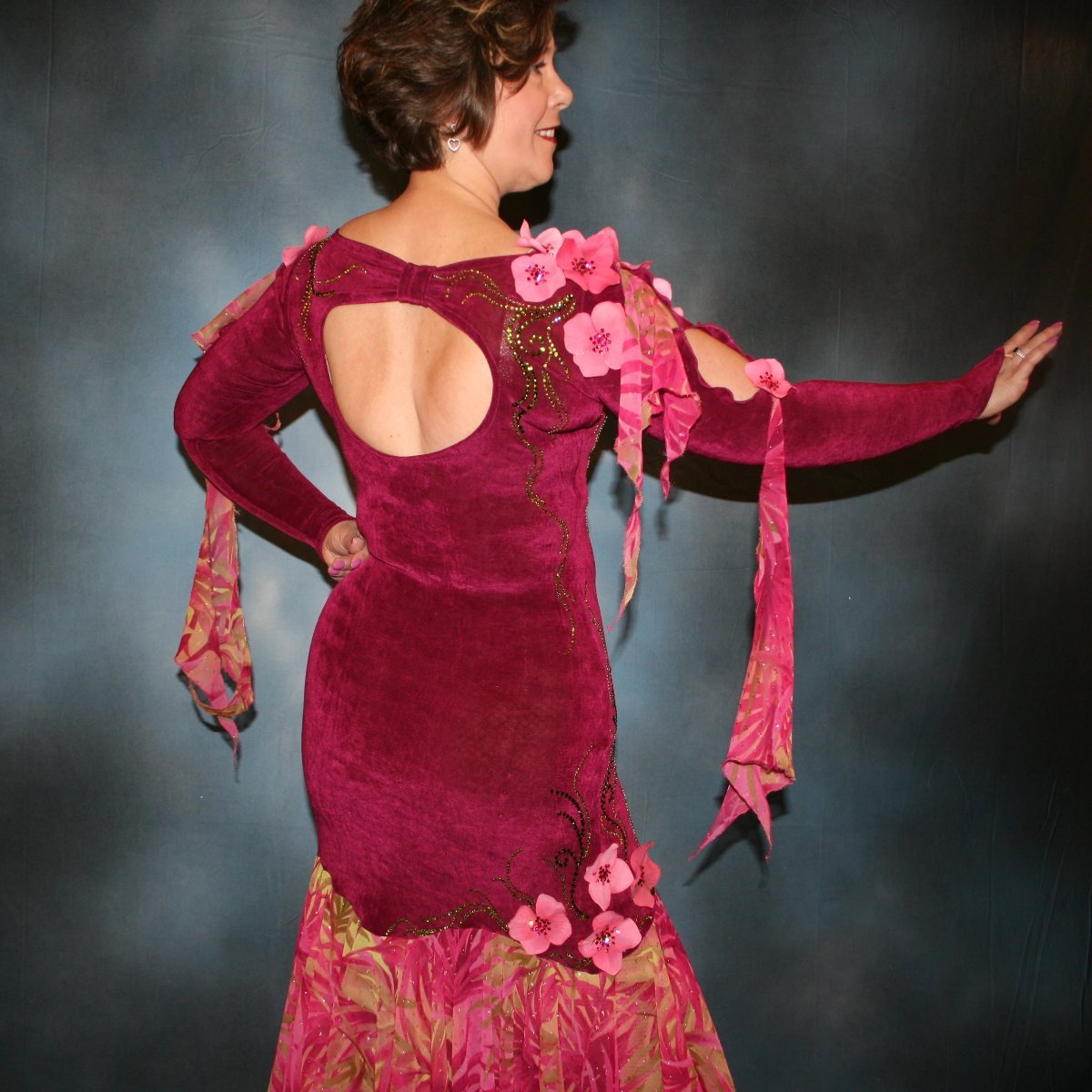Crystal's Creations close up back view of Cranberry ballroom dress, created in luxurious cranberry solid slinky with yards of exotic print of cranberries, pinks & touch of greens. Embellishments of Swarovski adorned silk flowers plus detailed Swarovski rhinestone work