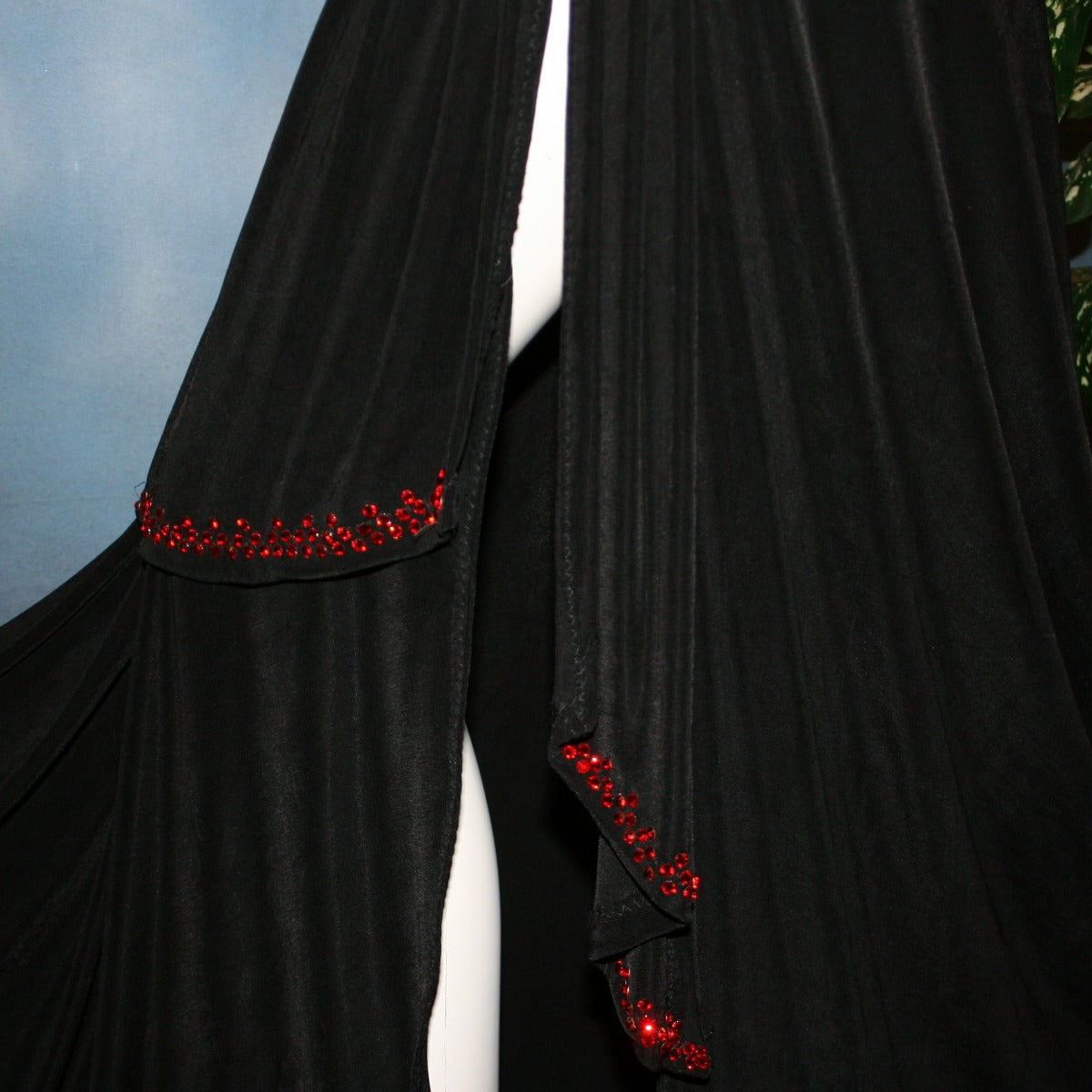 close view of Black Sarong wrap style ballroom skirt created in luxurious black solid slinky with light siam Swarovski rhinestone work on sash edges.