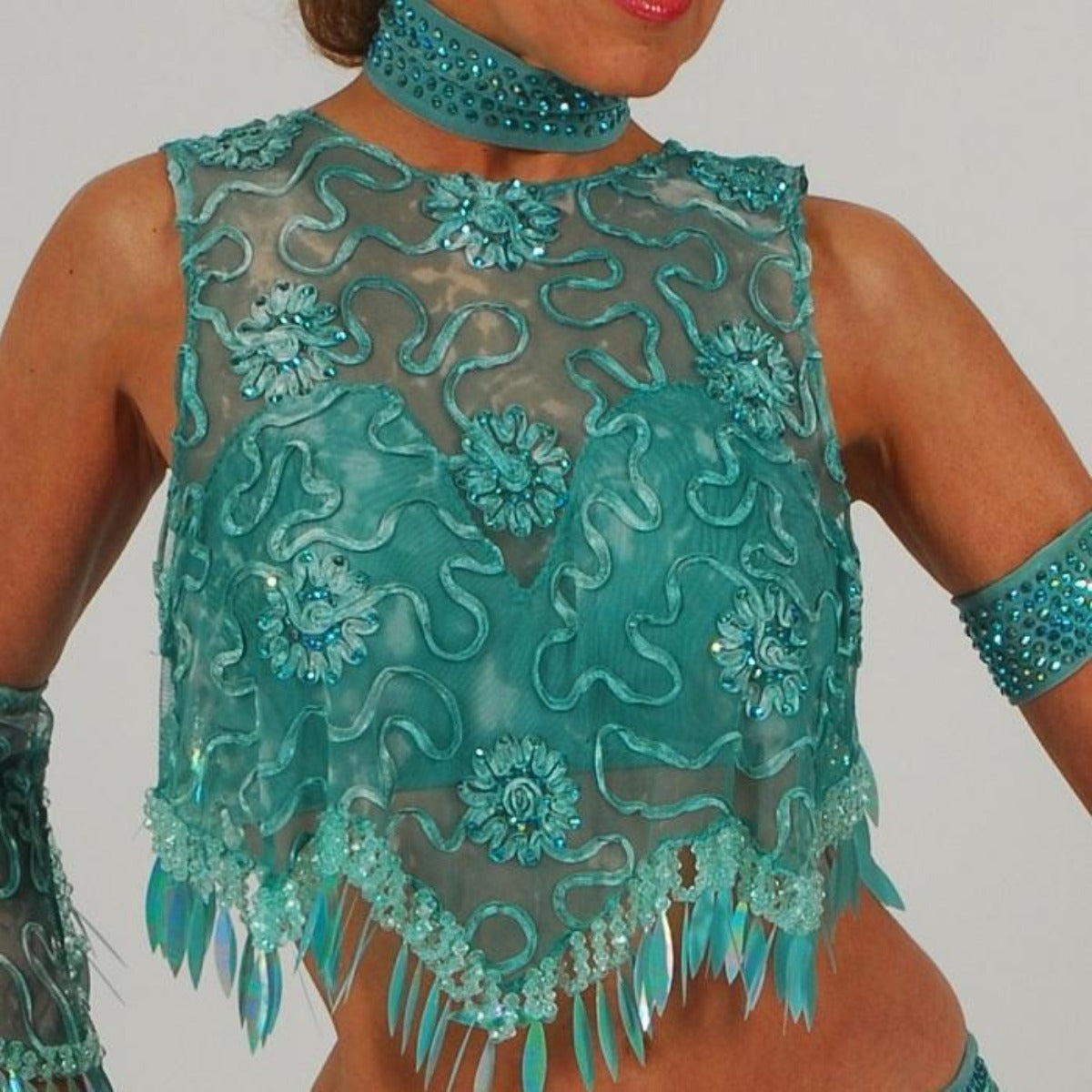 Crystal's Creations close up view of Gorgeous aqua Latin/rhythm two piece dance dress created of gorgeous aqua soutache lace fabric, embellished with about 10 gross of Aqua AB Swarovski stones with lots of hand beading & paillettes.