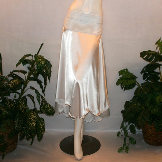 White dance skirt created of white stretch satin is waltz length, being a bit longer in the back with a scalloped hem.