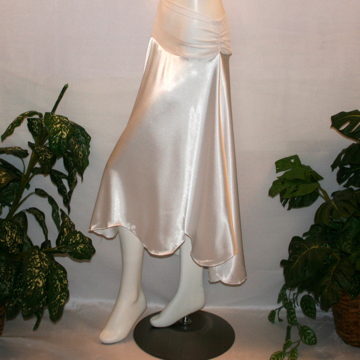 side view of White dance skirt created of white stretch satin is waltz length, being a bit longer in the back with a scalloped hem.