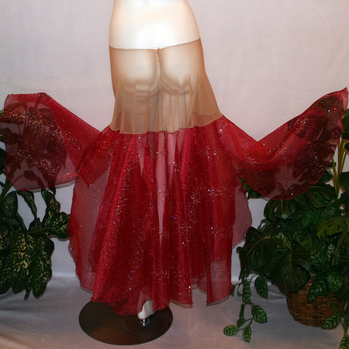 flaired back view of Red ballroom skirt created on a nude illusion hip band of yards of scarlette red panels with silver & pearlized flecking, very cool & showy!