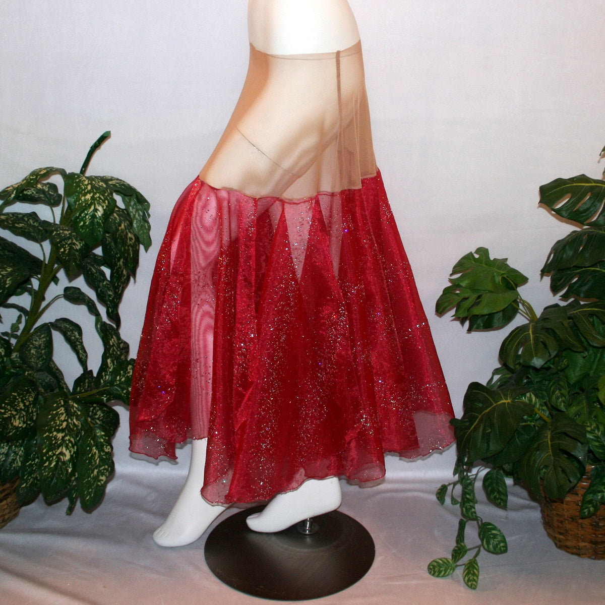 side view of Red ballroom skirt created on a nude illusion hip band of yards of scarlette red panels with silver & pearlized flecking, very cool & showy!