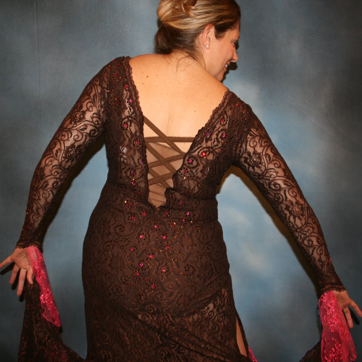 Crystal's Creations close up back view of Brown lace tango dress, fabulous bolero dress or rumba dress created in luxurious chocolate brown stretch lace with accent flounces of a deep pink glitter lace, embellished with Swarovski rhinestone detail work in copper & fuschia. 