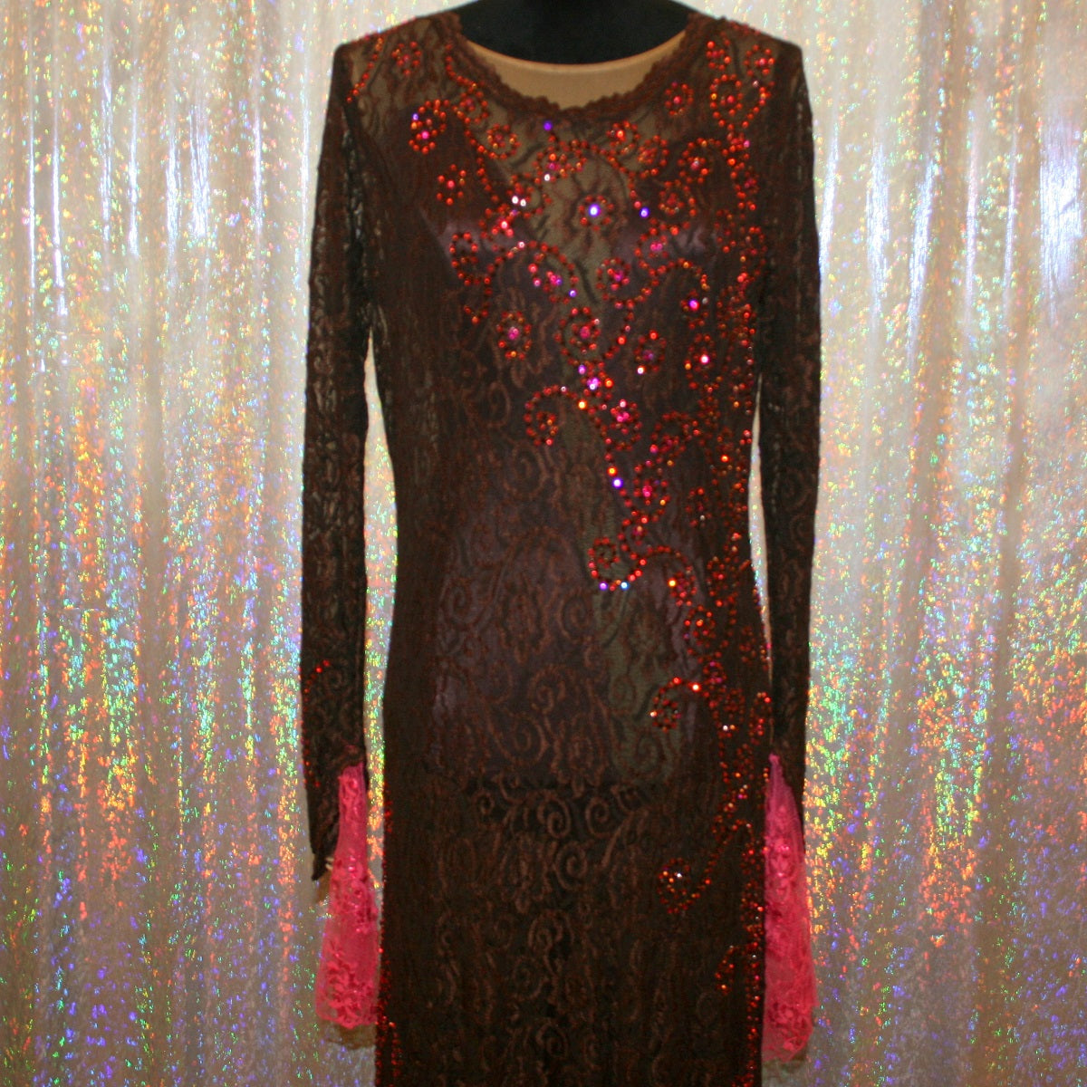 close up top view of Brown lace tango dress, paso dress, fabulous bolero dress or rumba dress created in luxurious chocolate brown stretch lace with accent flounces of a deep pink glitter lace, embellished with Swarovski rhinestone detail work in Indian pink, mocha,  & fuchsia.