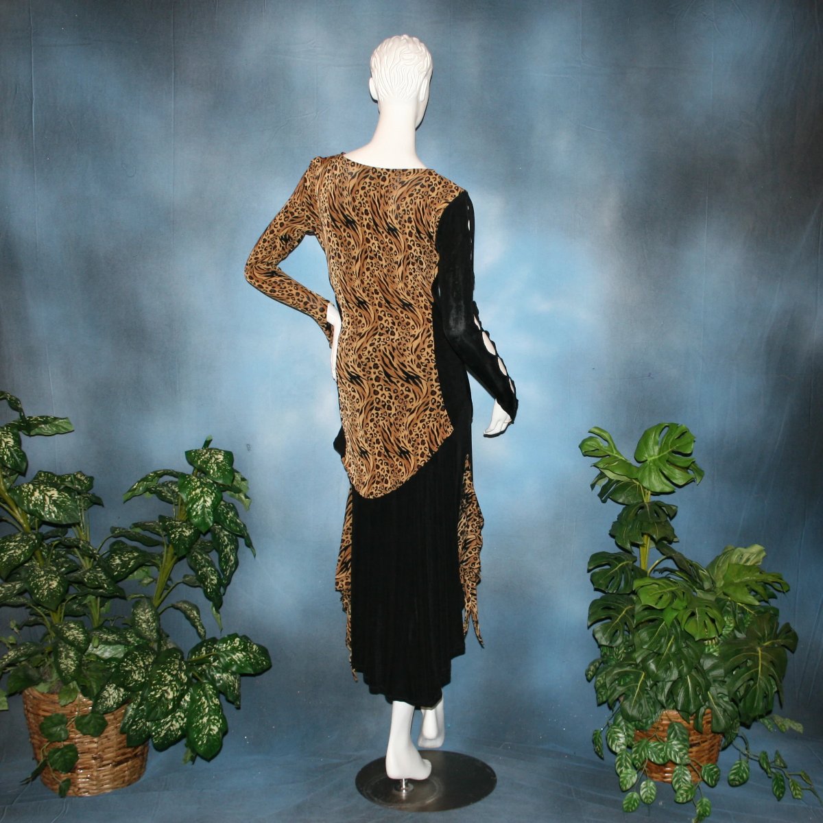back view of Ballroom social slinky dance set consisting of a black slinky Latin/rhythm skirt with serengeti print slinky & matching tunic top with color blocking & open detailing work in the long sleeves. The tunic top can be worn separately as a Latin/rhythm dress with dance trunks or a shorter little skirt can be custom made to go with it for an extra fee. You can also team the slinky tunic with pants. This slinky Latin/rhythm skirt & top is great for ballroom teachers!