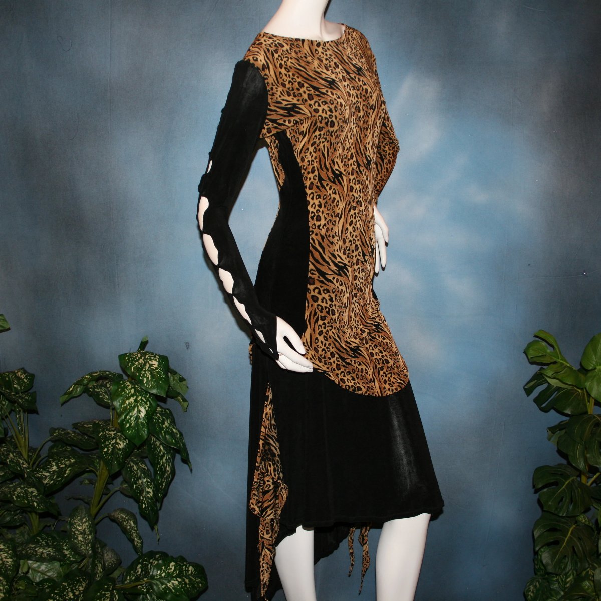 cloes side view of Ballroom social slinky dance set consisting of a black slinky Latin/rhythm skirt with serengeti print slinky & matching tunic top with color blocking & open detailing work in the long sleeves. The tunic top can be worn separately as a Latin/rhythm dress with dance trunks or a shorter little skirt can be custom made to go with it for an extra fee. You can also team the slinky tunic with pants. This slinky Latin/rhythm skirt & top is great for ballroom teachers!