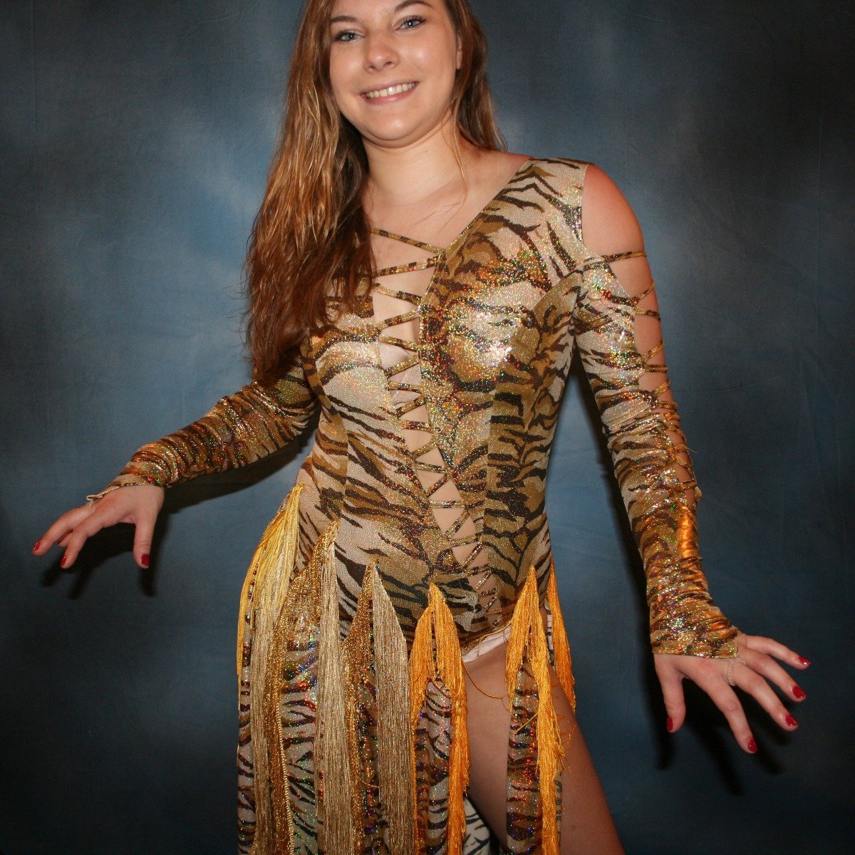 Crystal's Creations close up view of gold hologram tiger print Latin/rhythm dress with fringe size 5/6-9/10