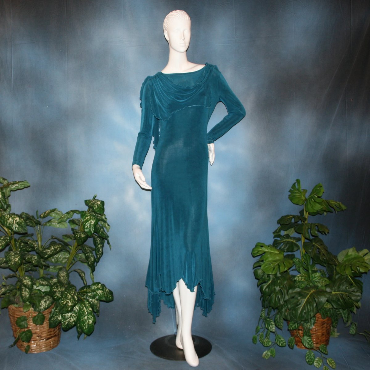 Blue social ballroom dress created in deep blue luxurious solid slinky fabric with attached draping on shoulders & scalloped skirt edge. Very full around bottom & can be a beginner ballroom dancer smooth dress.