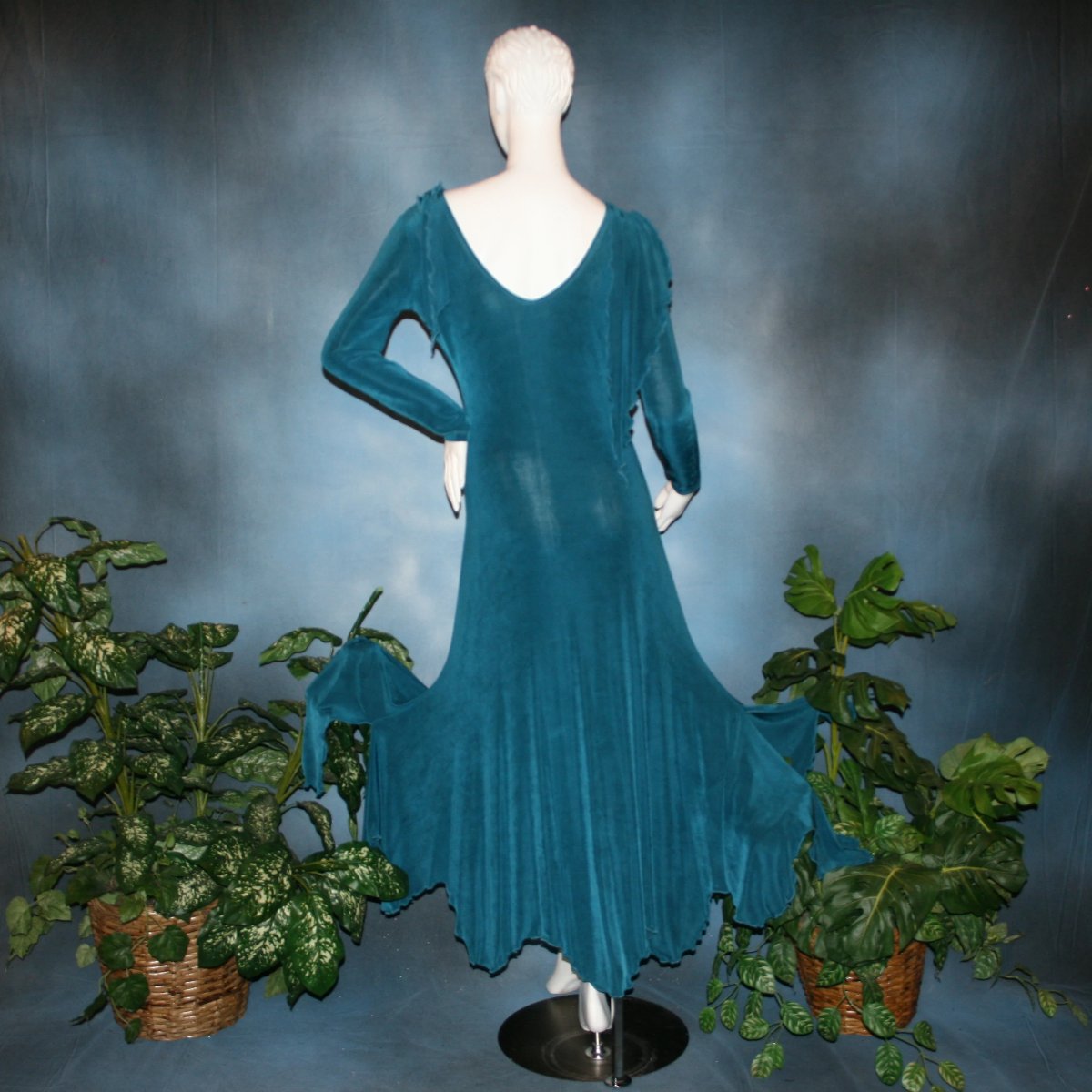 back view of Blue social ballroom dress created in deep blue luxurious solid slinky fabric with attached draping on shoulders & scalloped skirt edge. Very full around bottom & can be a beginner ballroom dancer smooth dress.