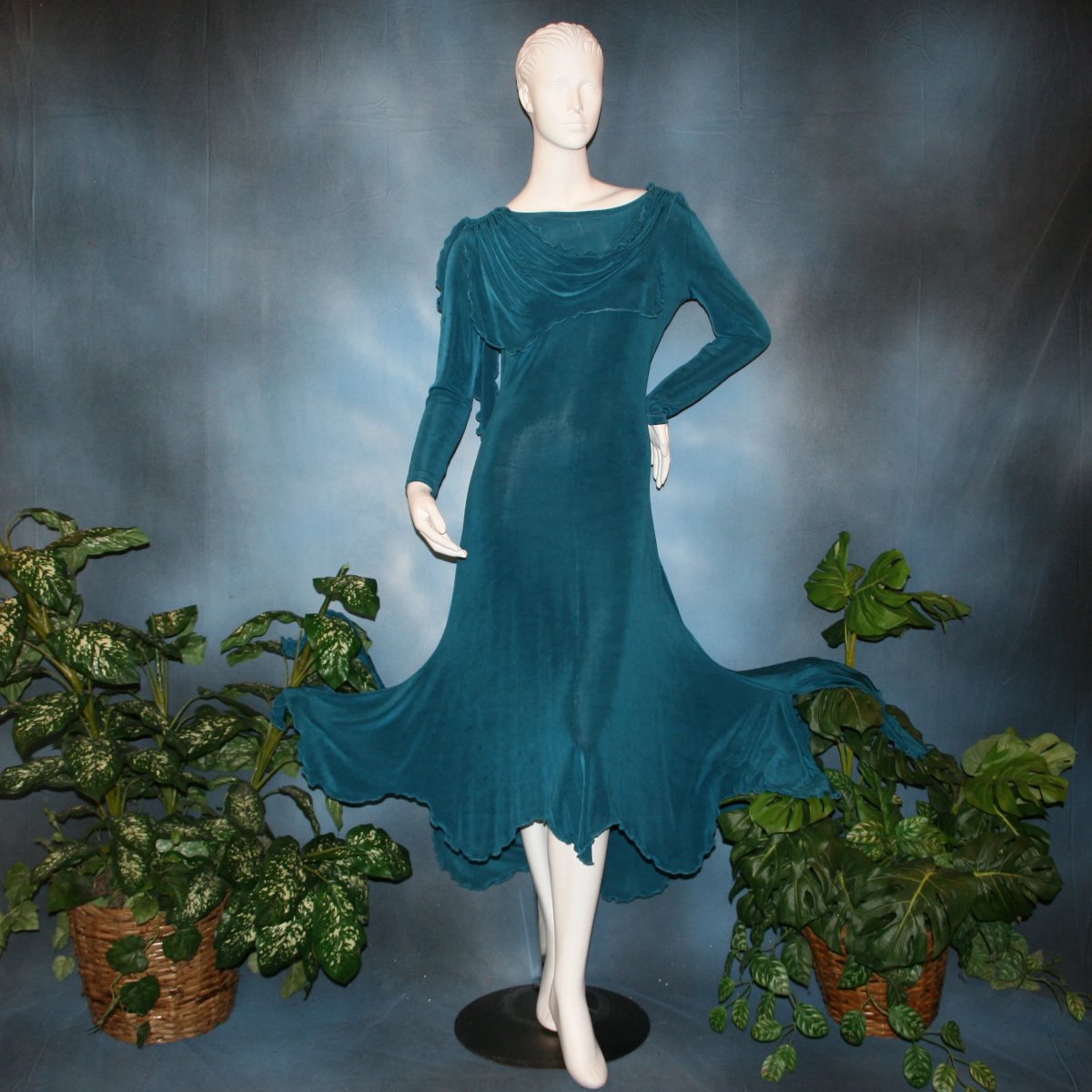 Blue social ballroom dress created in deep blue luxurious solid slinky fabric with attached draping on shoulders & scalloped skirt edge. Very full around bottom & can be a beginner ballroom dancer smooth dress.