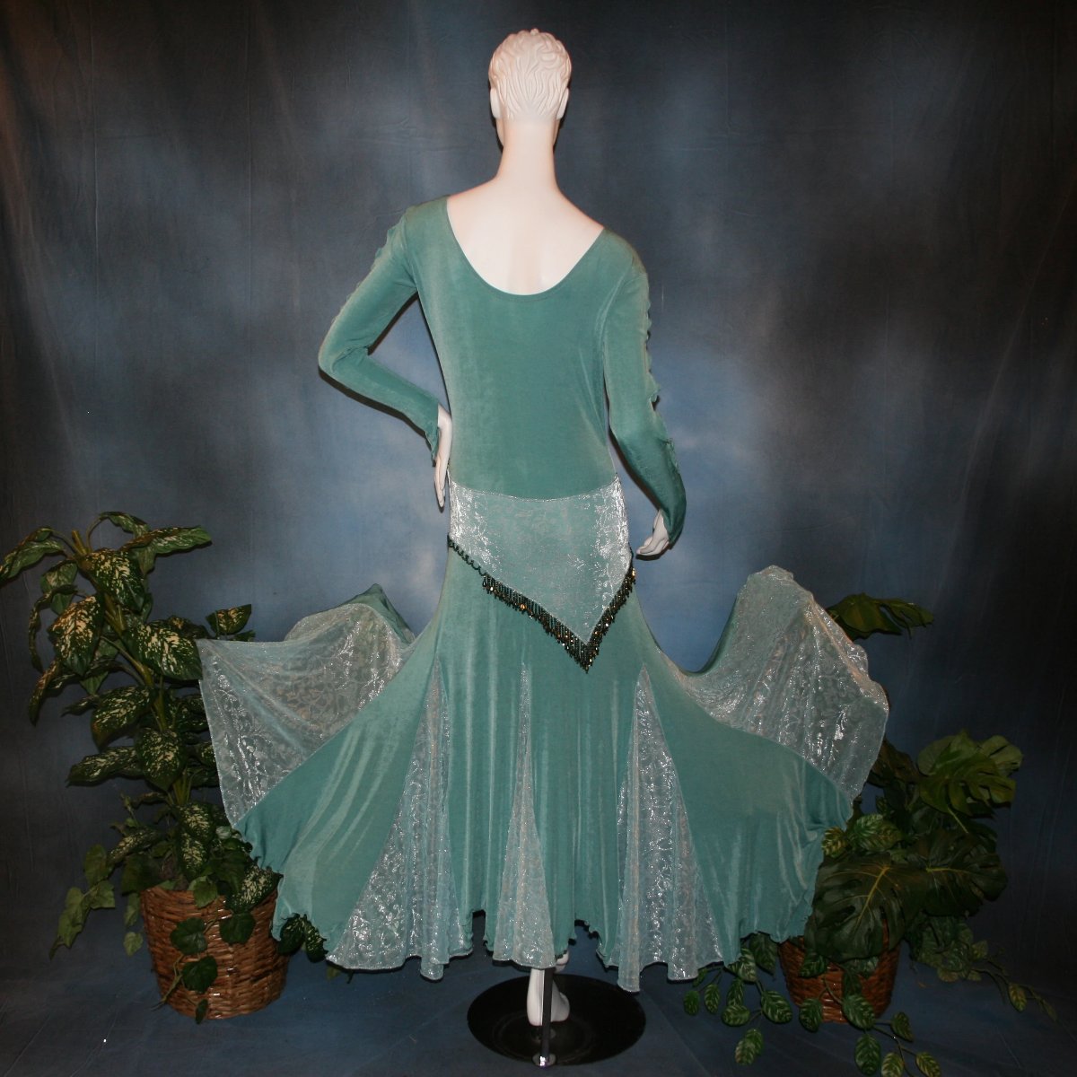 back view of Aqua social ballroom dress created in luxurious aqua solid slinky fabric with aqua iridescent sheer insets, embellished with hand beading of Swarovski beads on hip sash. Very full around bottom...can be a beginner ballroom dancer smooth ballroom dress.