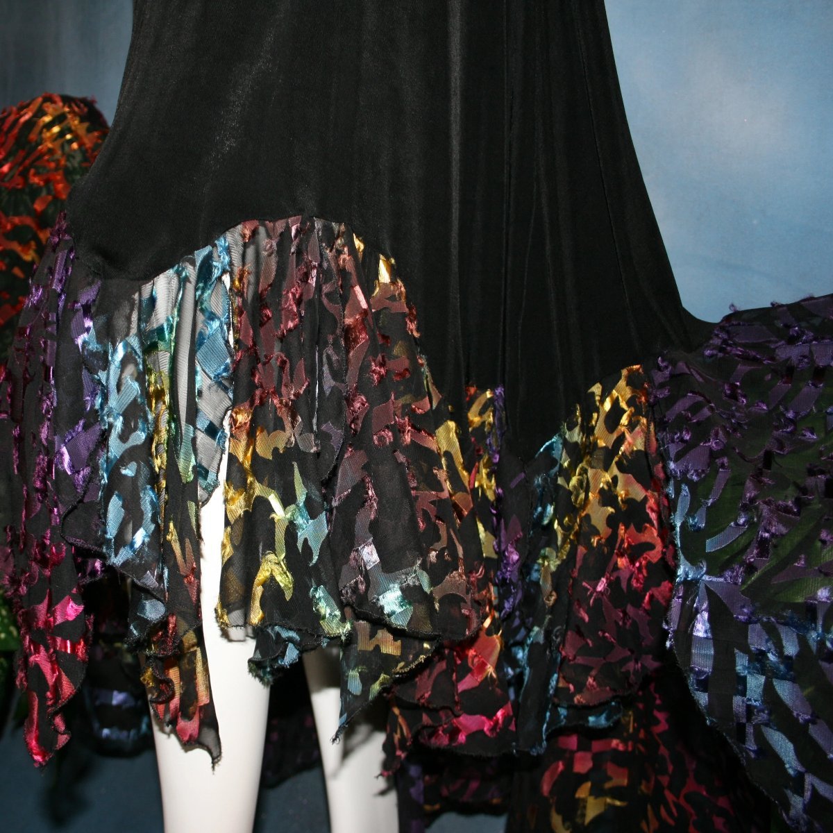 lower view of Black social ballroom dress created in luxurious black solid slinky fabric with yards of gorgeous rainbow colorful & textured sheer fabric. A great social dress for any special occasion, as well as a great beginner ballroom show dress!