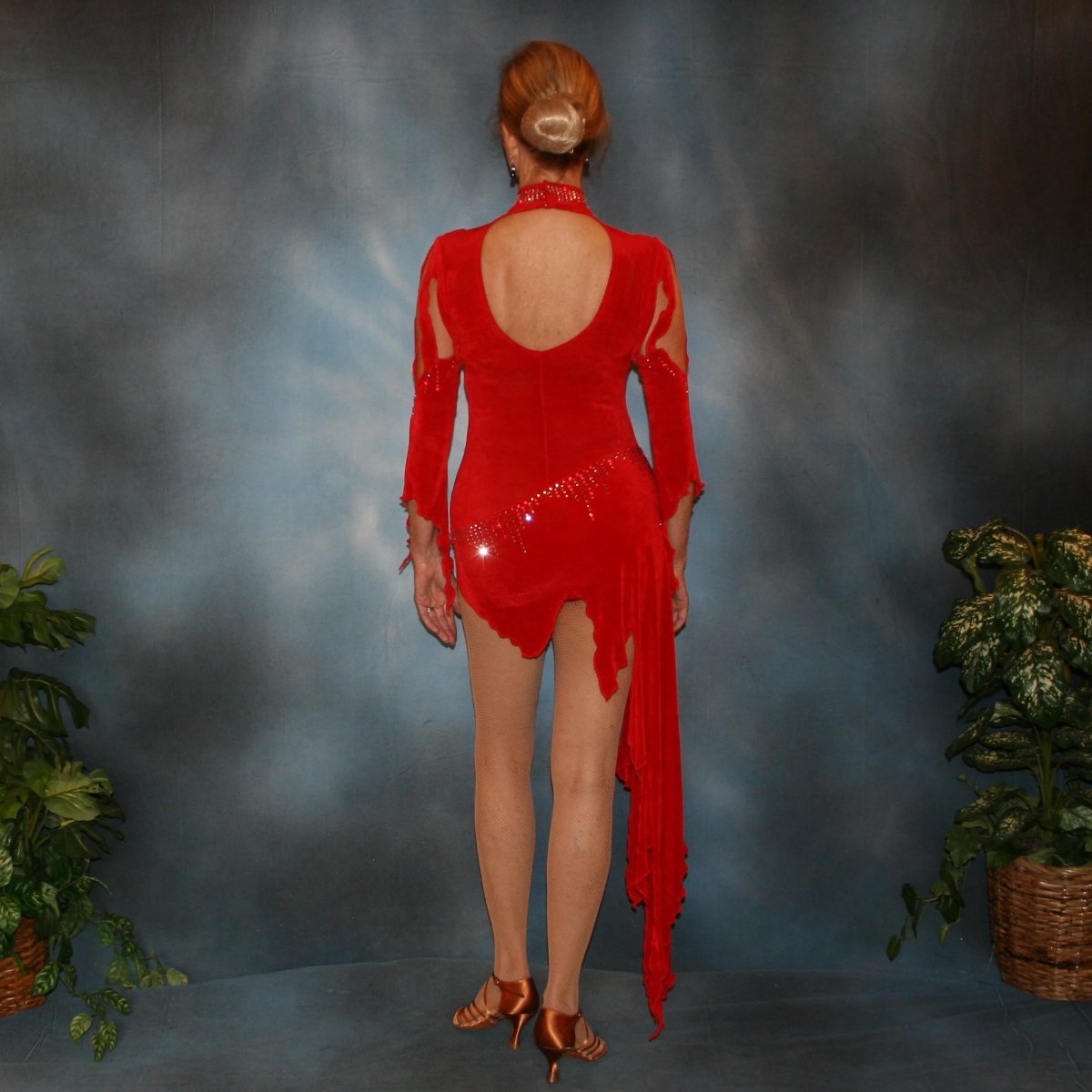 Crystal's Creations back view of Red Latin/rhythm dress, which consists of a bodysuit, featuring cutouts in bodice with a keyhole back, 3/4 sleeves with details & Latin/rhythm skirt, was created in luxurious red solid slinky embellished with light siam Swarovski rhinestone work.