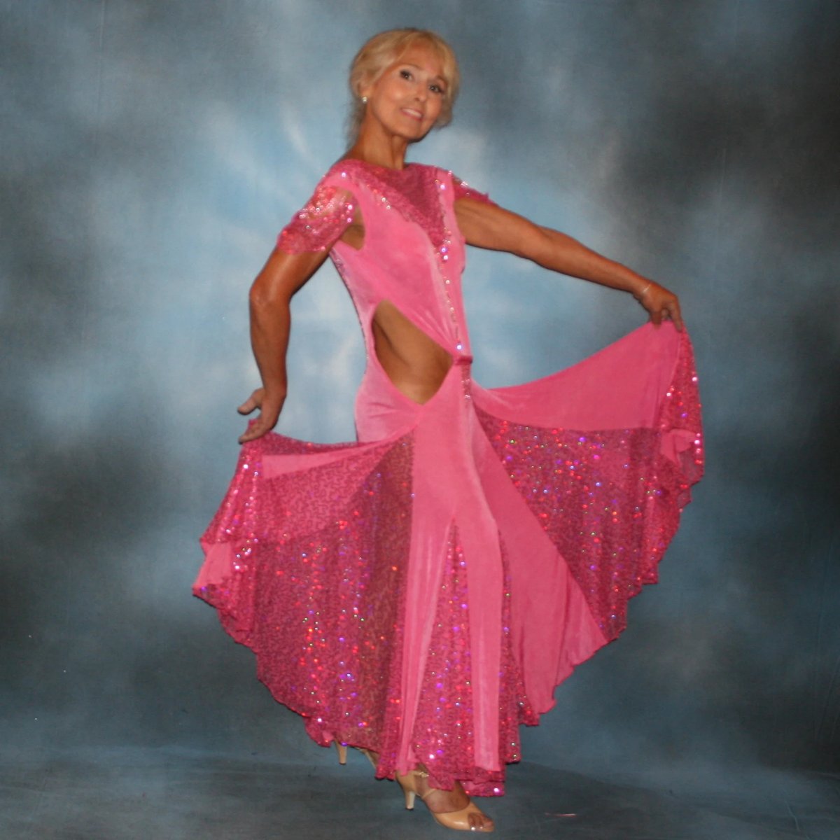 Crystal's Creations side view of Pink ballroom dress was created of luxurious bubble gum pink solid slinky with yards & yards of delicate deep pink sequin insets & is embellished with CAB & rose Swarovski detailed rhinestone work