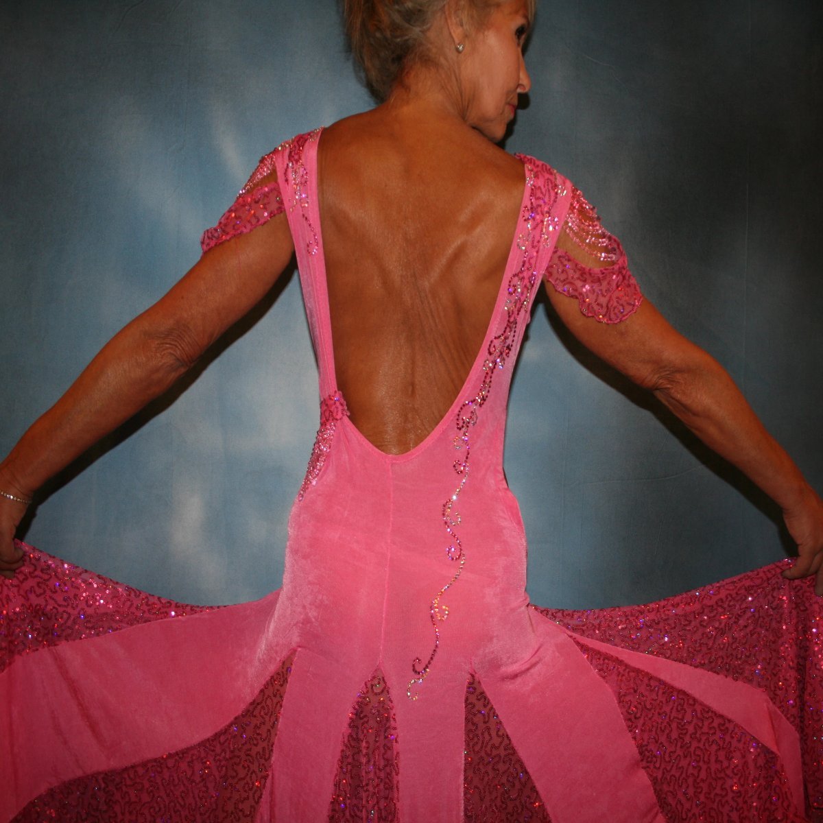 Crystal's Creations close up back view of Pink ballroom dress was created of luxurious bubble gum pink solid slinky with yards & yards of delicate deep pink sequin insets & is embellished with CAB & rose Swarovski detailed rhinestone work