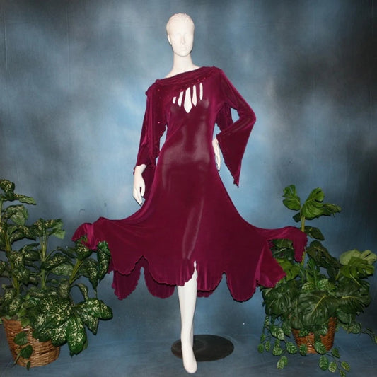 Magenta social ballroom dress created in luxurious solid slinky fabric with cutouts at bustline & attached double draping on shoulders, embellished with magenta Swarovski rhinestones, features a scalloped skirt edge. Very full around bottom & can be a beginner ballroom dancer smooth ballroom show or competition dress.
