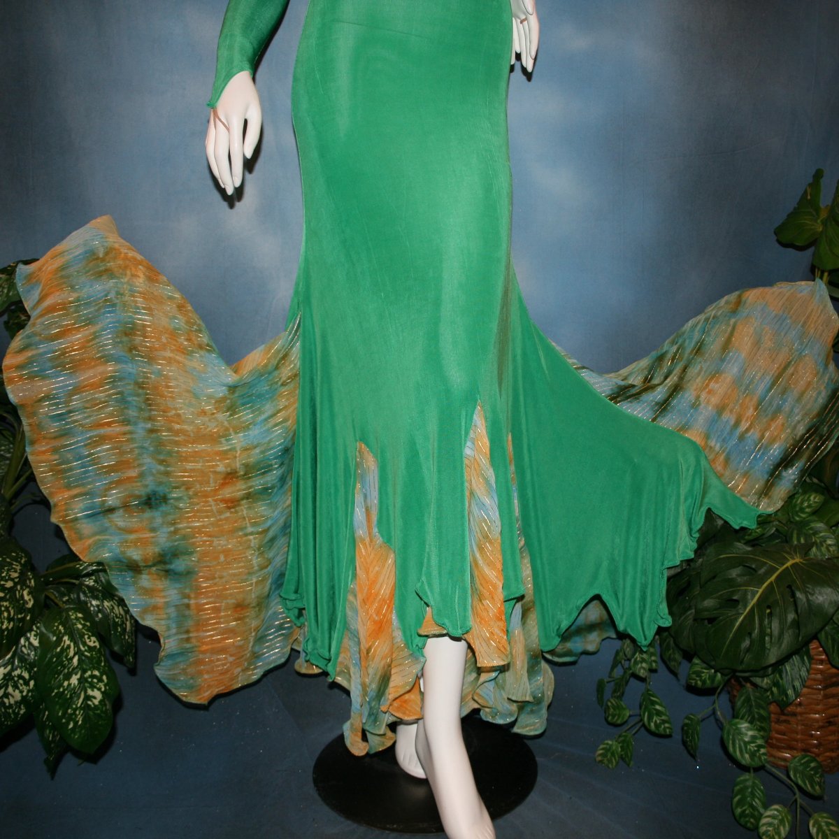 lower view of Gorgeous green ballroom dress created in luxurious solid slinky fabric with printed chiffon of greens, with gold accents insets. Very full around bottom...can be a beginner ballroom dancer smooth or standard dress.