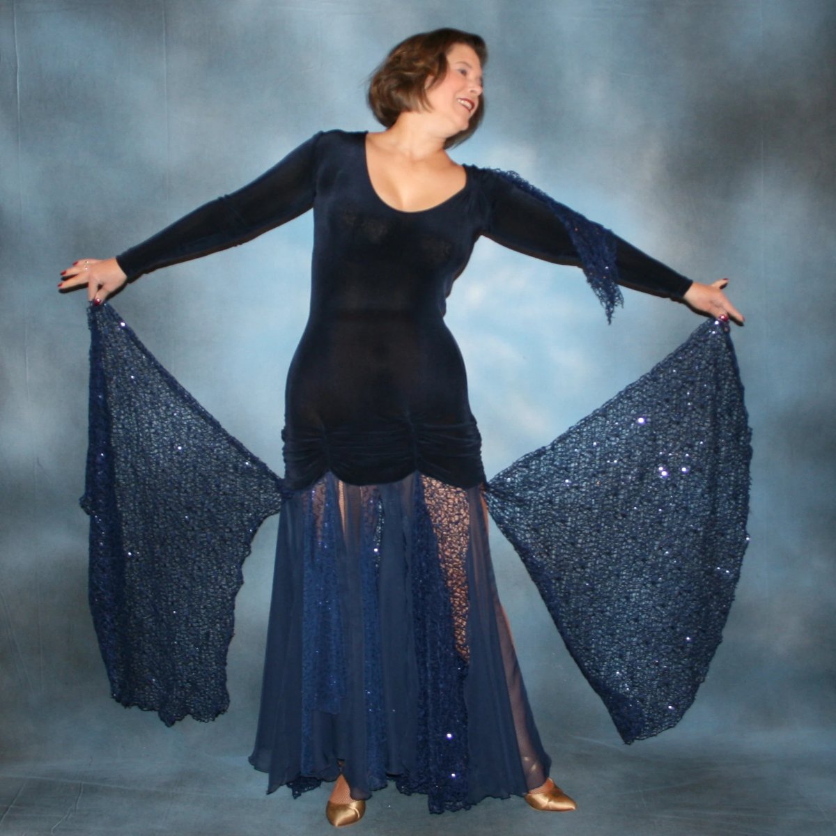 Crystal's Creations Ballroom dress created in luxurious navy blue solid slinky fabric with yards of gorgeous unique sequined mermaid net look lace & chiffon. The bottom of base of dress has ruching at the hip. A great social dress for any ballroom dance or special occasion, as well as a great beginner show dress!