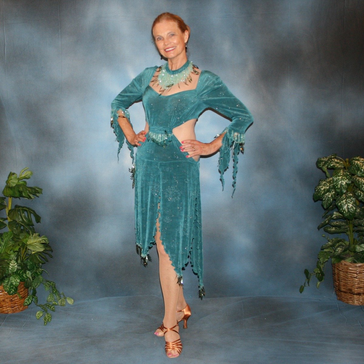 Crystal's Creations Teal Latin/rhythm dress was created in teal glitter slinky with a subtle gold glitter floral print, embellished with light teal faceted round lucite beading & teal spangles, includes a matching neckpiece.