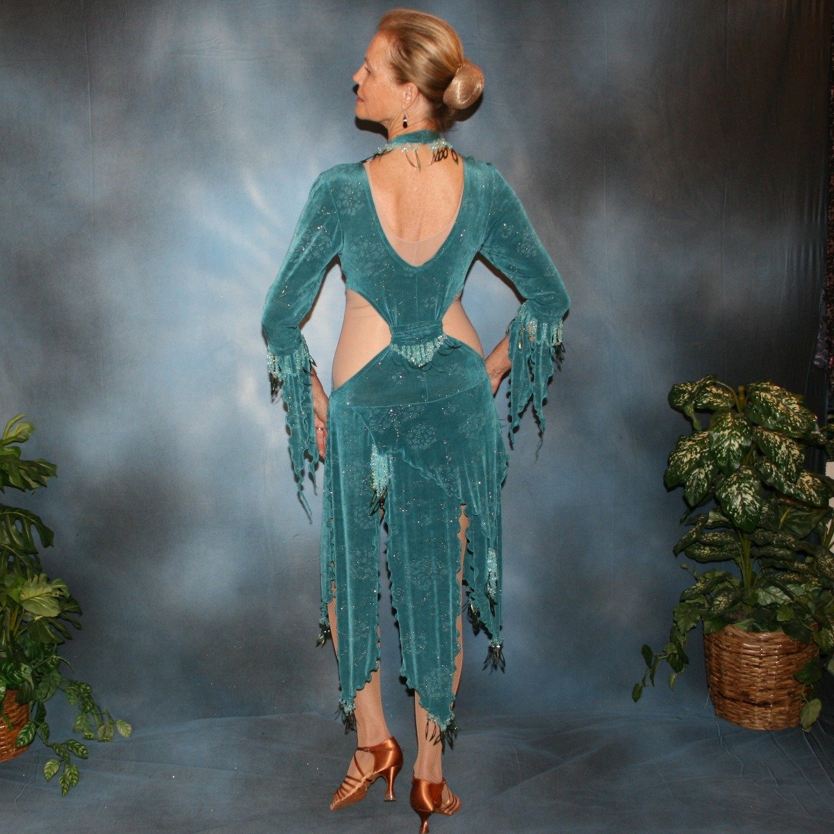 Crystal's Creations back view of Teal Latin/rhythm dress was created in teal glitter slinky with a subtle gold glitter floral print, embellished with light teal faceted round lucite beading & teal spangles, includes a matching neckpiece.