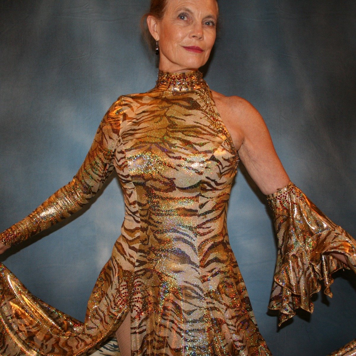 Crystal's Creations close up view of gold hologram tiger print tango dress with many flounces & volcano colored Swarovski rhinestone work size 5/6-9/10