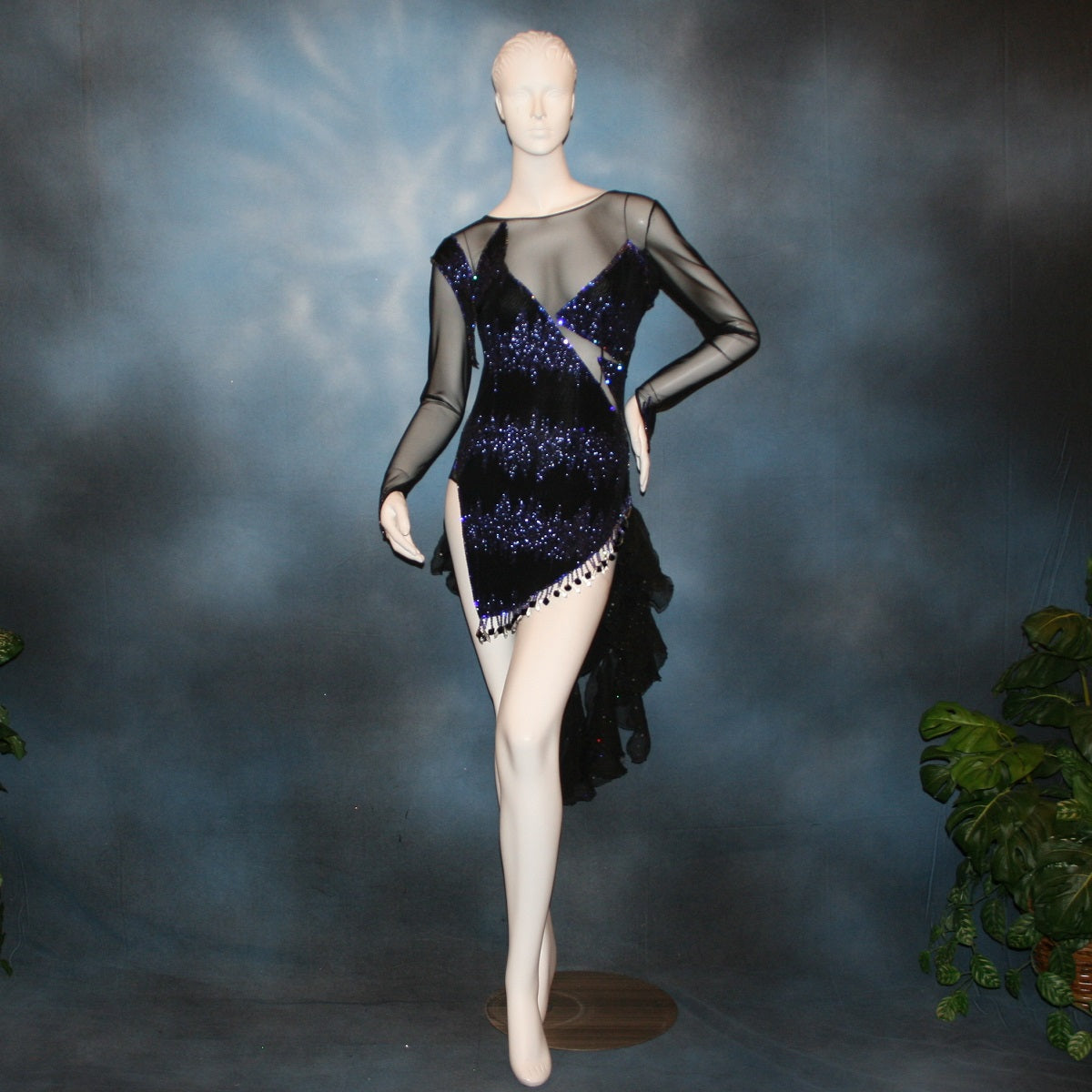 Crystal's Creations Latin/rhythm/tango dress created in black glitter slinky with an awesome electrifying tanzanite/perwinkle glitter pattern artistically placed on a black stretch mesh base, embellished with crystal heliotrope Preciosa rhinestone work, hand beading & features flounces in the back skirting.