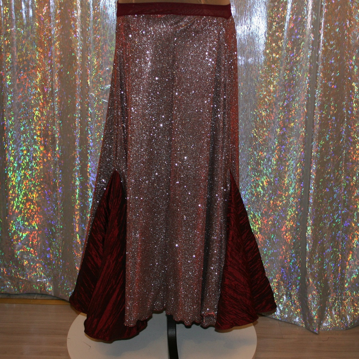 Ballroom dance skirt created of a very sparkly knit that shimmers silver & wine colors with insets of a 3 color pleated satin that looks wine colored with this particular fabric. 