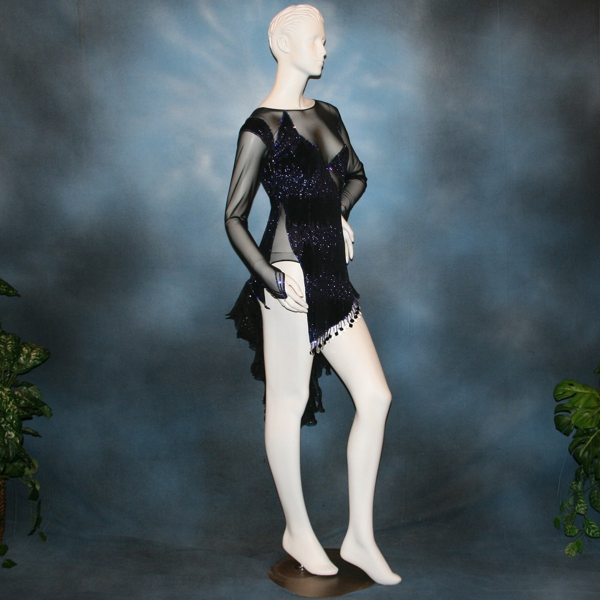 Crystal's Creations right side view of Latin/rhythm/tango dress created in black glitter slinky with an awesome electrifying tanzanite/perwinkle glitter pattern artistically placed on a black stretch mesh base, embellished with crystal heliotrope Preciosa rhinestone work, hand beading & features flounces in the back skirting.
