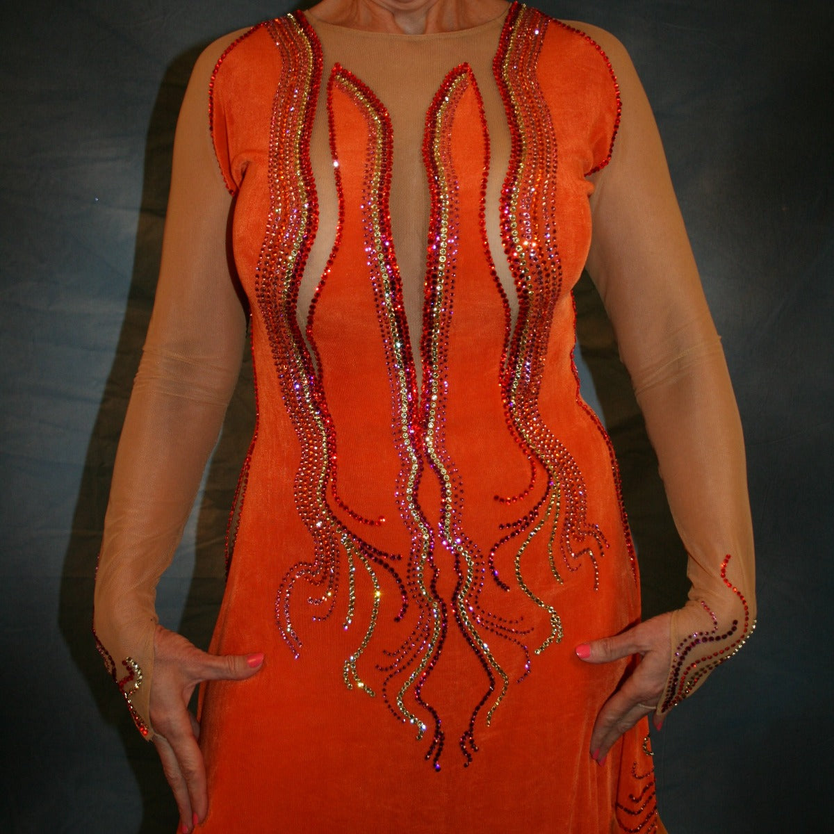 Crystal's Creations close up view of Sunny orange ballroom dress created in luxurious solid slinky with gorgeous printed chiffon in bursts of orange, pink & yellow, is embellished with Swarovski rhinestone work of orange hyacynth, rose, jonquil & fuschia. 