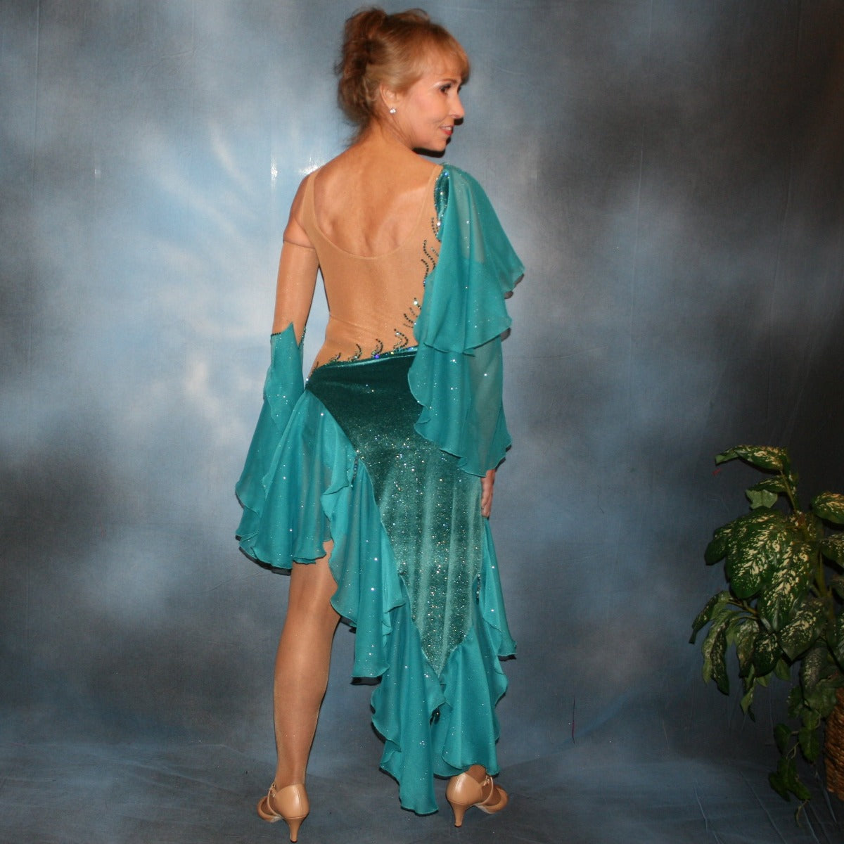 Crystal's Creations back view of Teal Latin/rhythm dress was created on a nude illusion base with luxurious teal glitter stretch velvet fabric along with flounces of teal glitter chiffon, embellished with blue zircon & blue zircon Ab Swarovski stonework plus hand beaded detailing