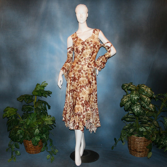 Ballroom social dress created of brown tropical print lycra with shiny gold accents through the print, features low back & cold shoulder 3/4 sleeves with flounces & lattice strap details, & lots of flounces through the full skirting