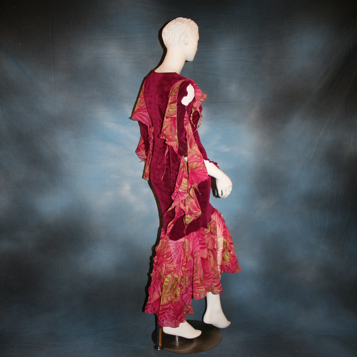 side view of Cranberry sleek social Latin/rhythm dress created in luxurious cranberry solid slinky fabric with printed sheer flounces & floats. 